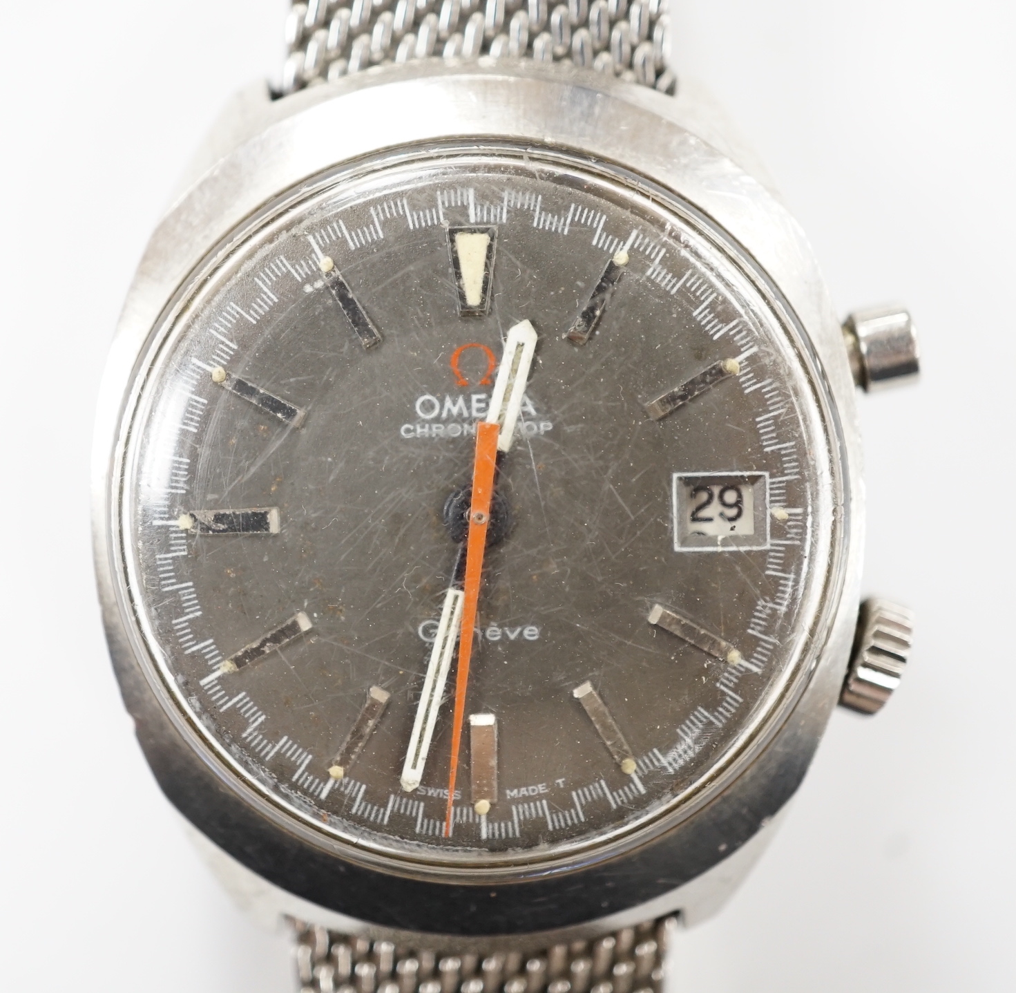 A gentleman's 1970's? stainless steel Omega Chronostop manual wind wrist watch, on a steel Omega mesh link bracelet.